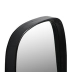 Angled close-up of the mirror's rounded top showing the textured surface and depth of the dark frame.
