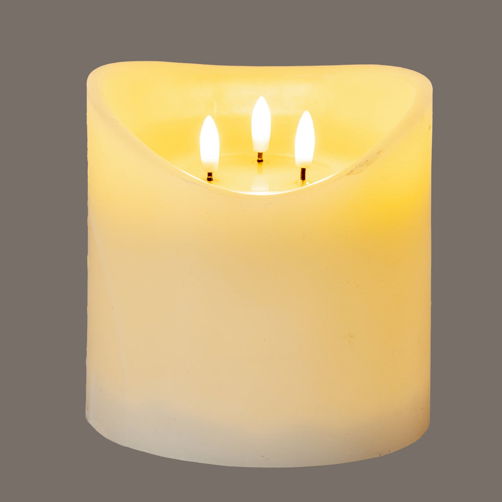 Cream LED candle shown illuminated against a grey background, with three bright flame-shaped elements inside its recessed top.