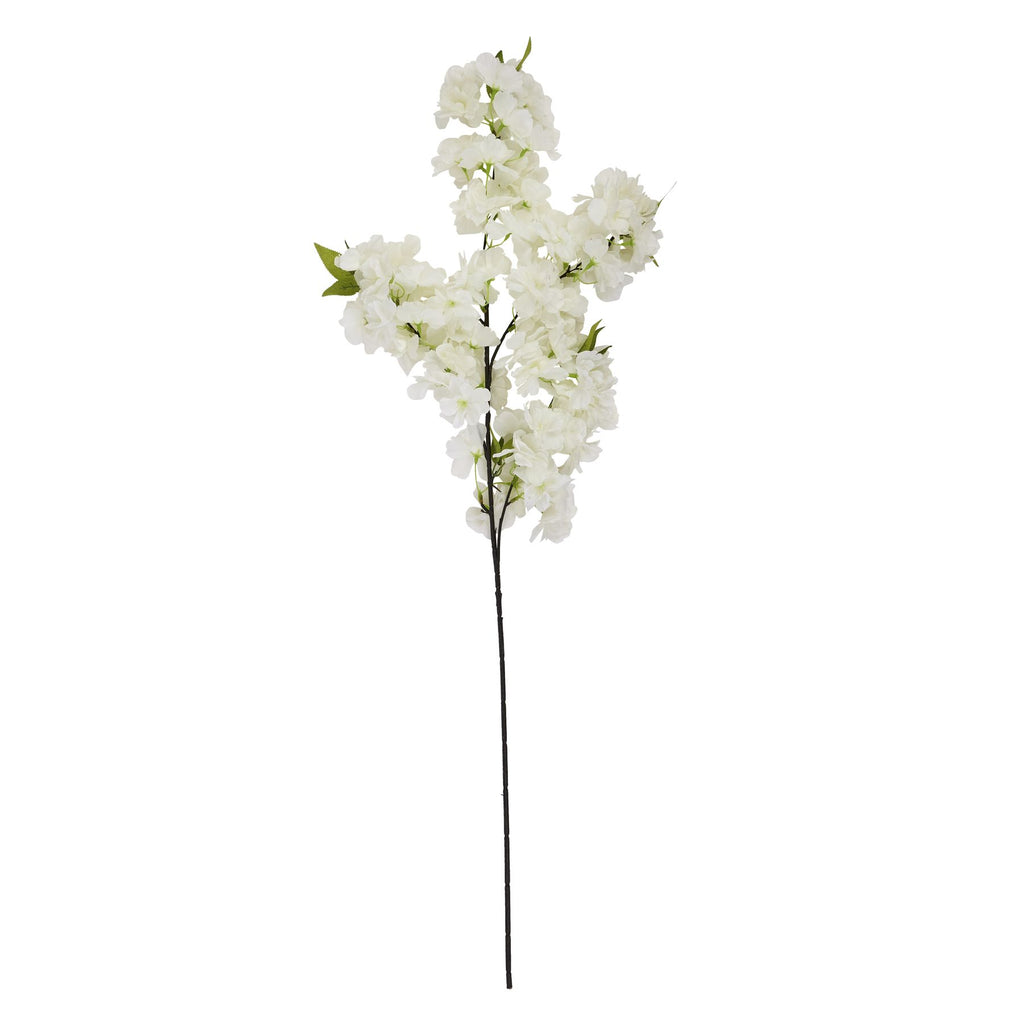 Full view of the artificial blossom stem, with dense white flowers on dark branches above a long bare stalk.