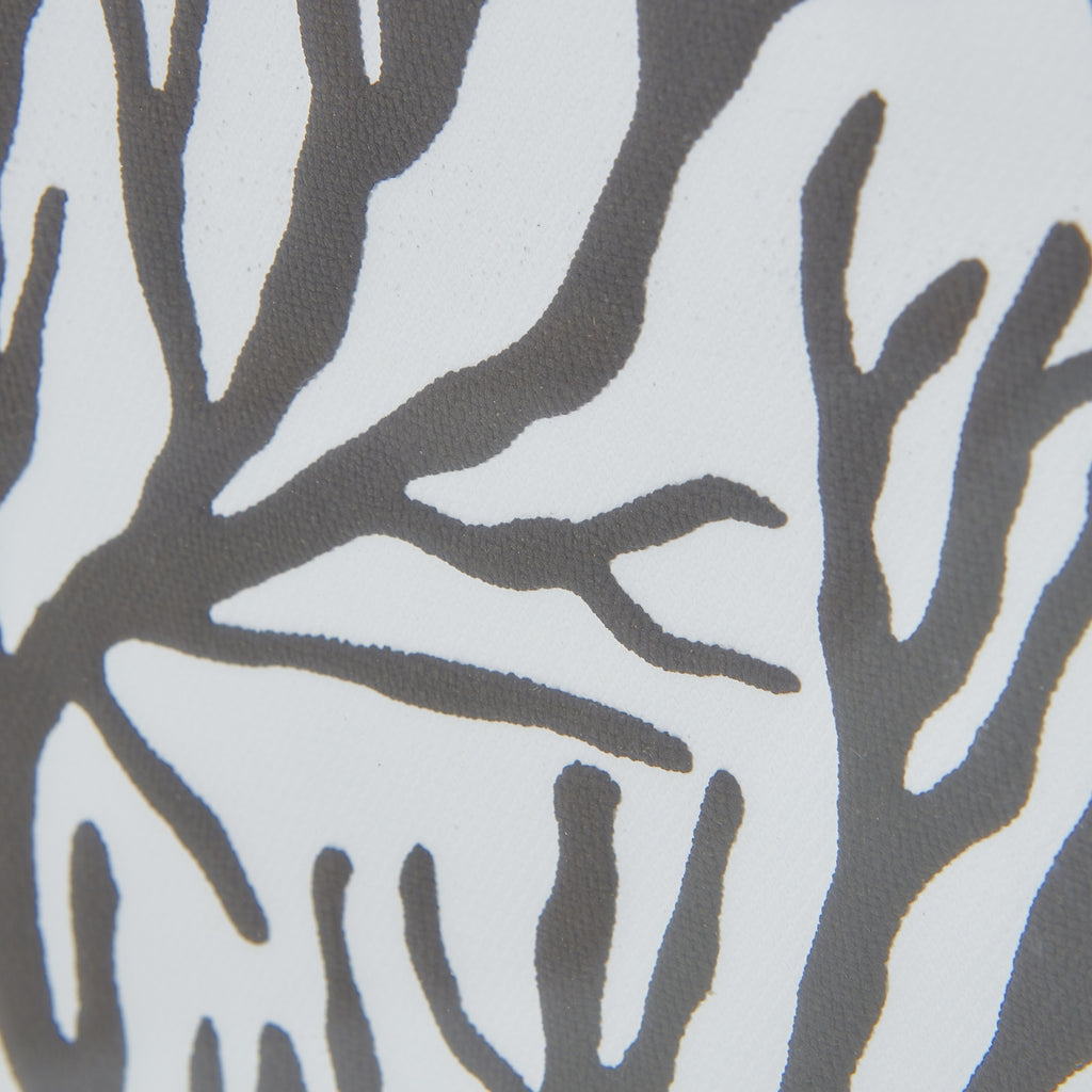 Close-up of dark-grey branching shapes against a pale ground, revealing the graphic's irregular edges and fine surface texture.