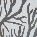 Close-up of dark-grey branching shapes against a pale ground, revealing the graphic's irregular edges and fine surface texture.