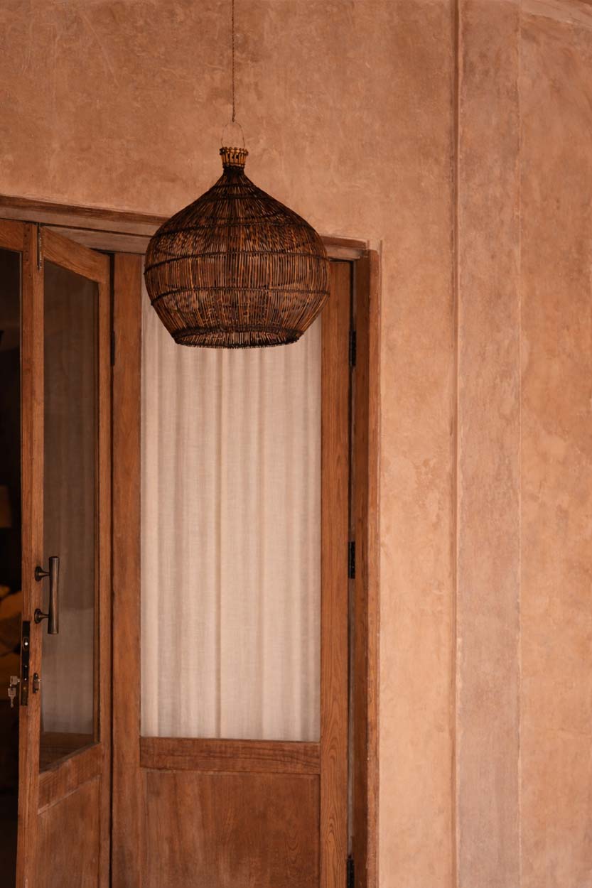 Desert Gourd Rattan Pendant Light – Dark Walnut, Small – styled in a narrow hallway
