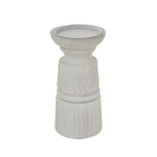 Full view of the pale candle holder with its rounded top, ringed middle and cylindrical fluted base against white.