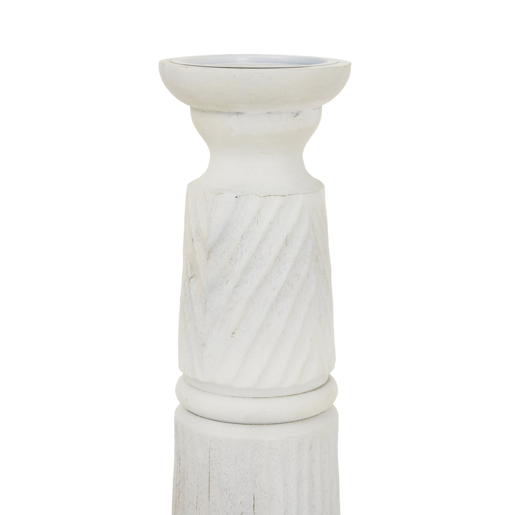 Close view of the candle holder's recessed top and curved neck above the pale diagonal relief bands.