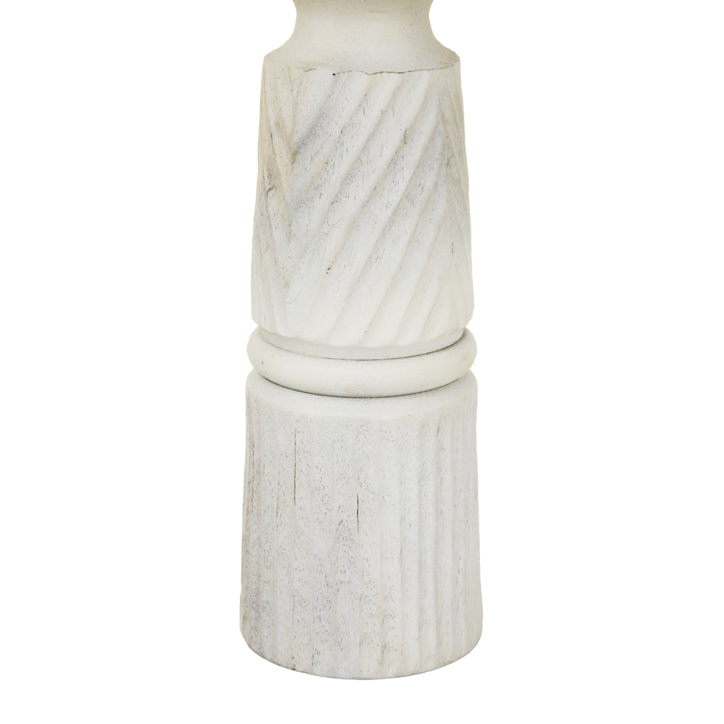 Detail of diagonal bands meeting a rounded ring above the vertically fluted base, with darker markings visible through the whitewash.