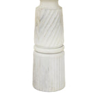 Detail of diagonal bands meeting a rounded ring above the vertically fluted base, with darker markings visible through the whitewash.