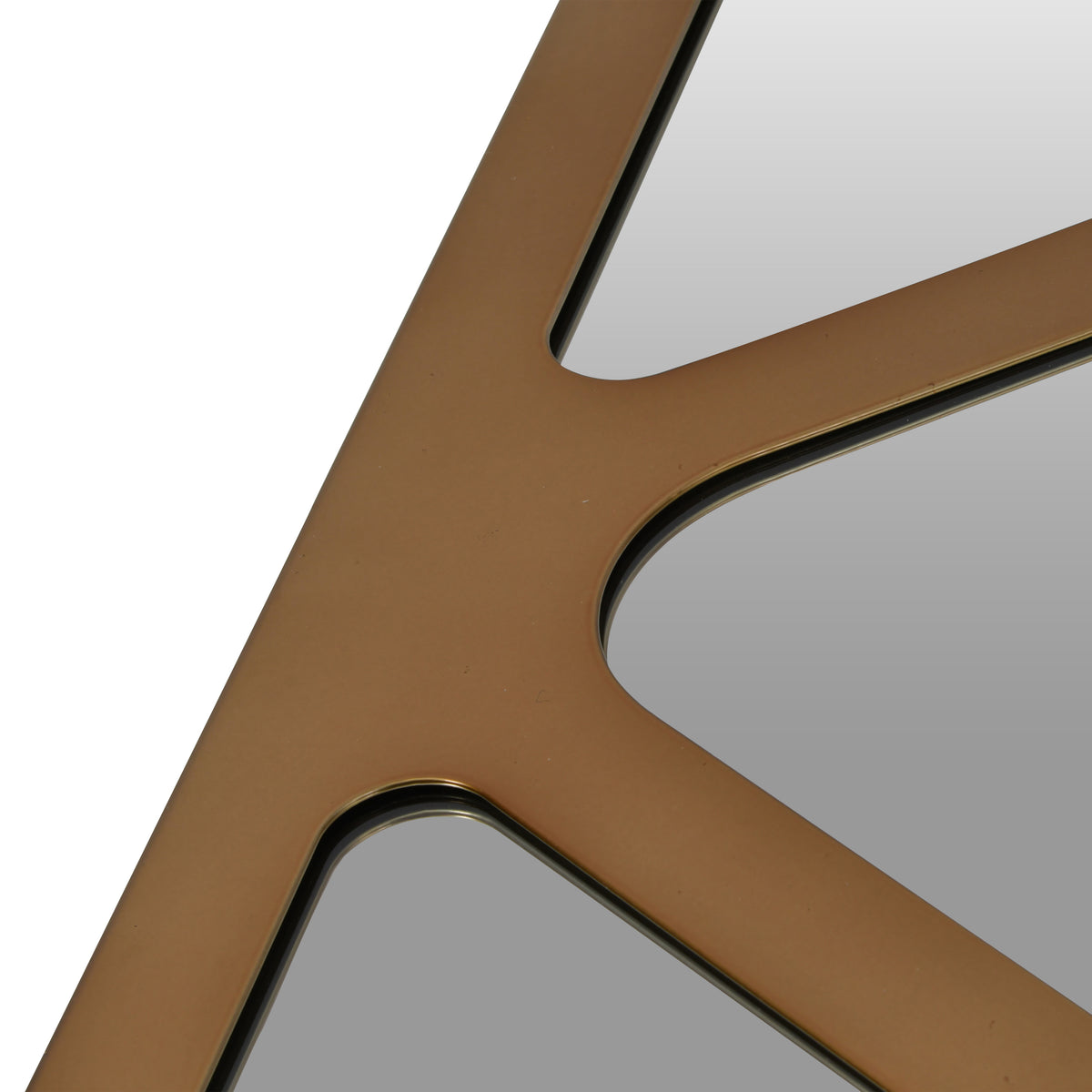 Close-up of bronze-coloured frame sections meeting between mirrored panels with rounded corners.
