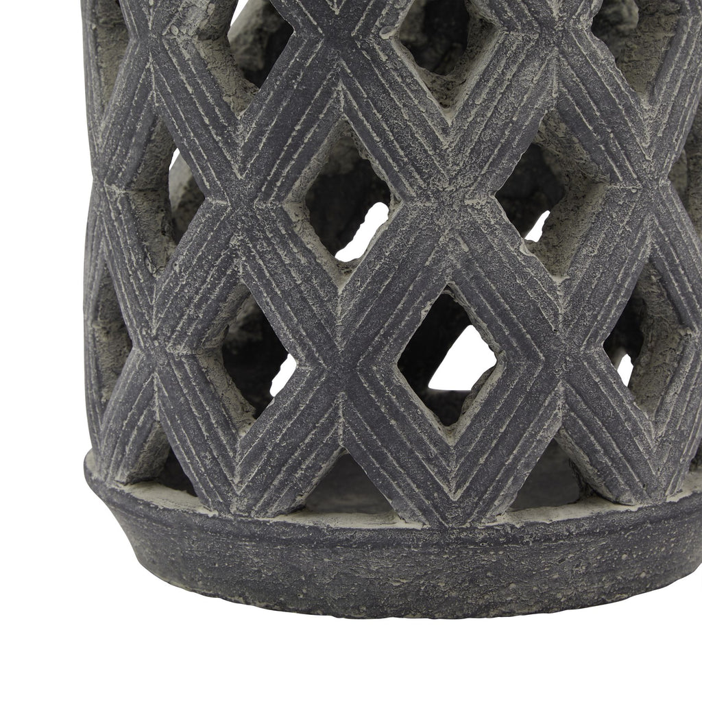 Close-up of the lower diamond lattice and circular base, showing parallel lines along the diamond shapes and the weathered grey surface.