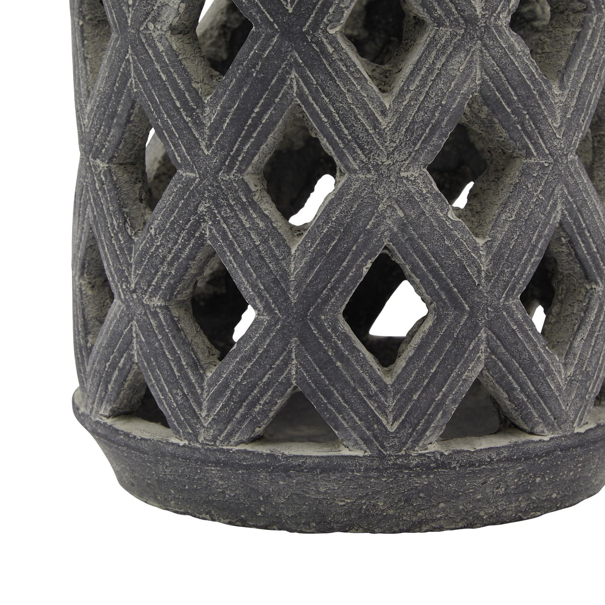 Close-up of the lower diamond lattice and circular base, showing parallel lines along the diamond shapes and the weathered grey surface.
