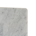 Close-up of the serving board's rounded corner and softened edge, showing hazy grey markings across the pale surface.