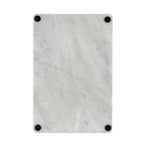 Underside of the rectangular serving board with four black circular pads near the corners.