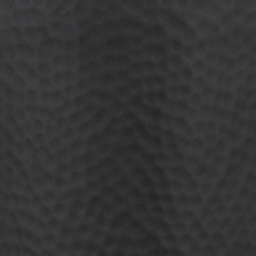 Close-up of the black vase surface, showing its fine matt finish and shallow rounded dimples.