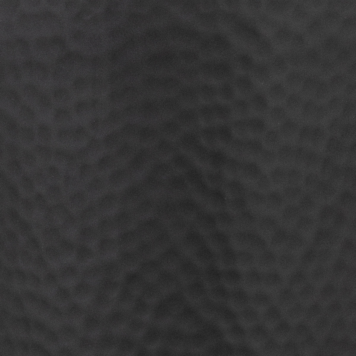 Close-up of the black vase surface, showing its fine matt finish and shallow rounded dimples.