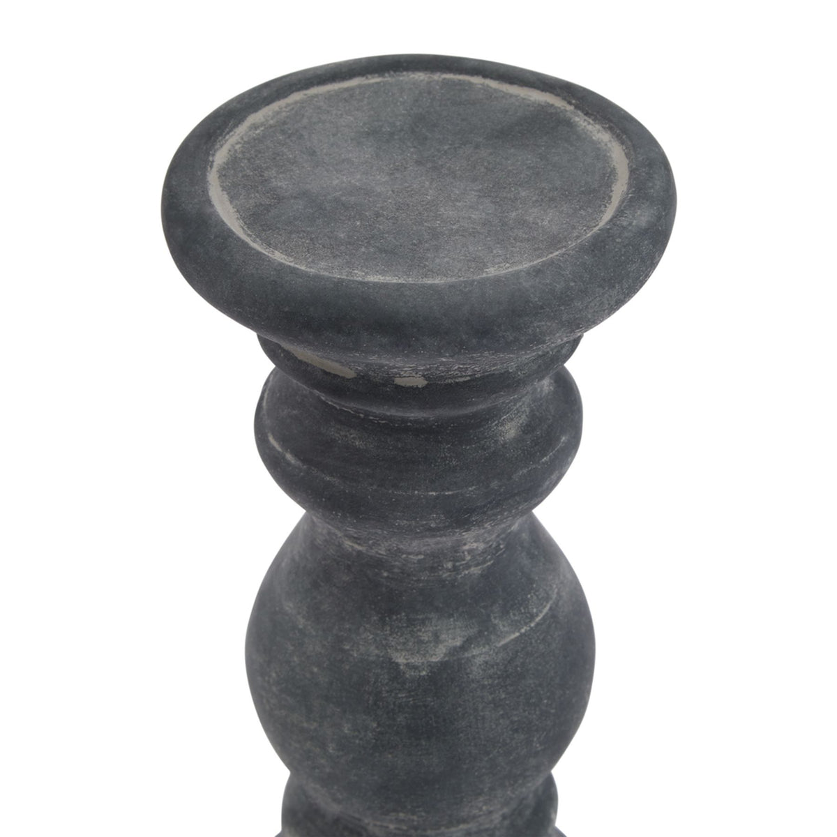 Close view from above of the candle holder's shallow top dish, with a rounded rim and pale distressed markings around the inner edge.