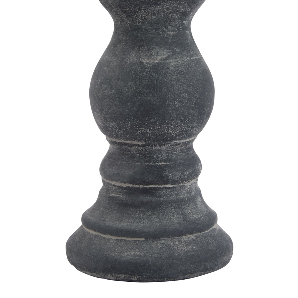 Detail of the candle holder's rounded lower stem and stepped foot, showing pale speckling and lighter lines across the dark grey ring details.