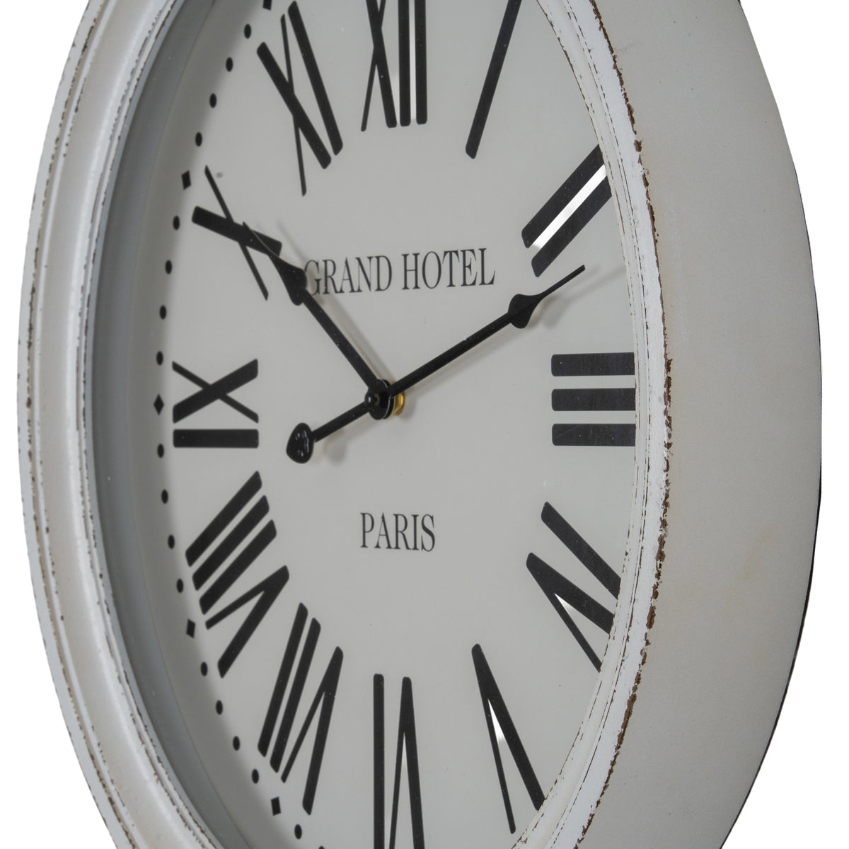 Angled close-up of the pale clock face, showing the shaped black hands and dark distressed marks along the white rim.