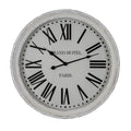 Front view of the round white wall clock with a distressed rim, black Roman numerals and GRAND HOTEL PARIS lettering.