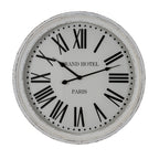 Front view of the round white wall clock with a distressed rim, black Roman numerals and GRAND HOTEL PARIS lettering.