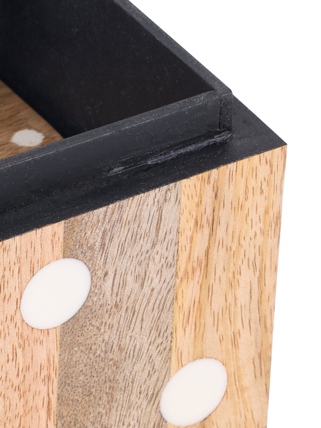 Close view of the open box corner, showing the dark lining, raised rim, wood grain and white resin dots.