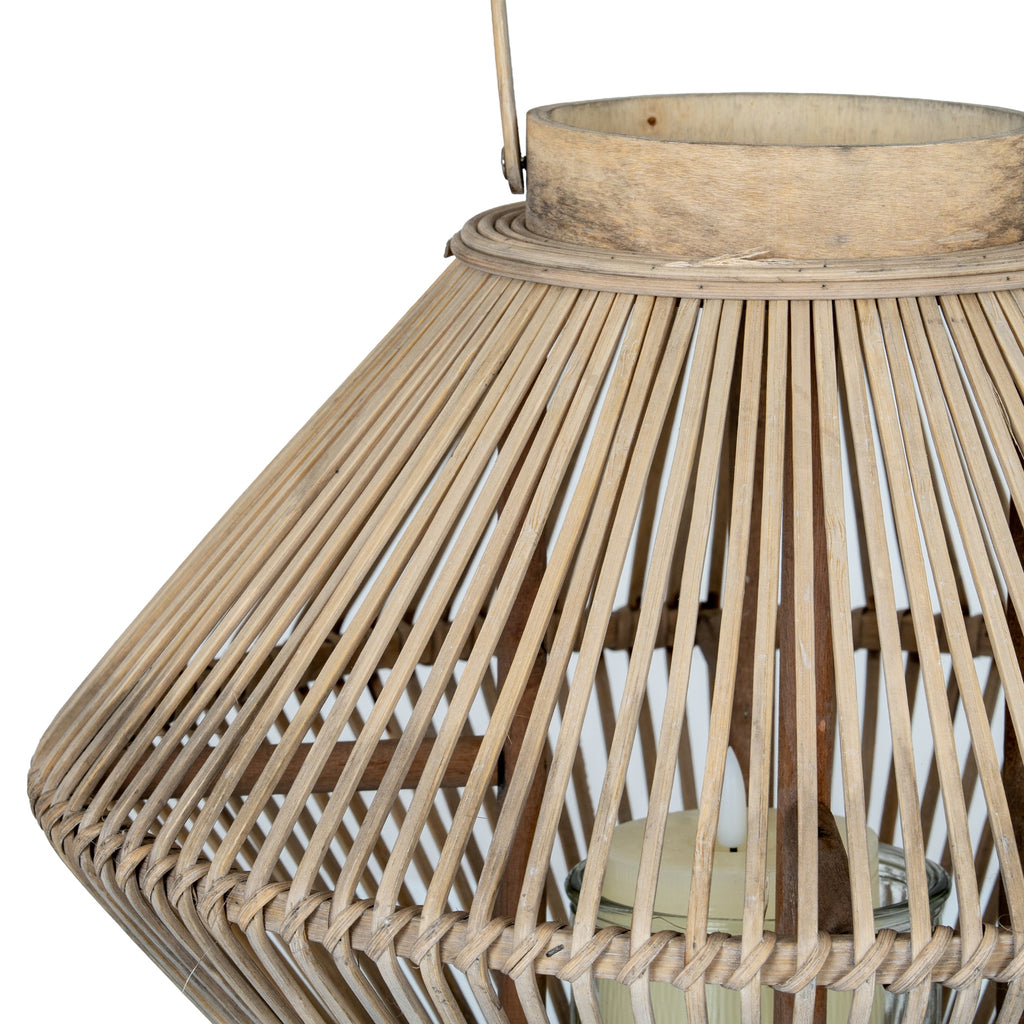 Close-up of the lantern's tan slats bending around the broad centre, with an unlit candle visible inside the cylindrical holder.