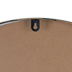 Rear detail of the black keyhole hanging bracket at the clock's curved top edge.