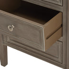 Middle drawer pulled open to show its brown interior and side, with a framed grey-brown front and round silvery knob.