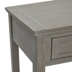 Angled detail of the console's top corner, showing the pale streaks in the grey finish, projecting top edge and framed drawer front.