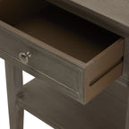 Drawer pulled open to show its brown interior and side panel above the table's lower shelf.