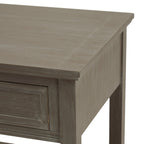 Detail of the table's projecting top edge, grey-washed side panel and framed drawer corner.