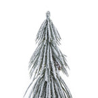 Close-up of the tree's pointed top and layered drooping green fronds covered in white snow effect, with a brown cone among the foliage.
