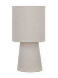 Unlit beige linen table lamp with a cylindrical drum shade and tapered cone base against a white background.