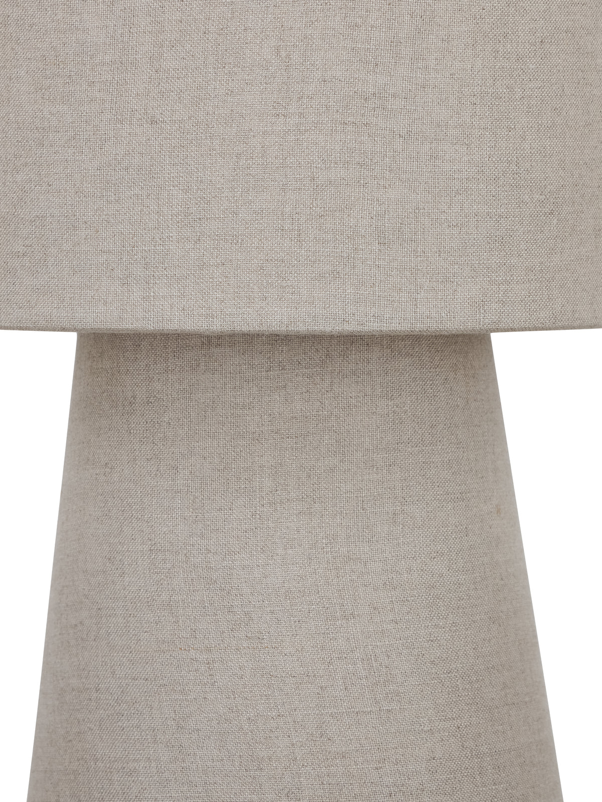 Tight detail of the shade meeting the tapered base, showing fine threads and tonal variation in the natural-coloured linen.