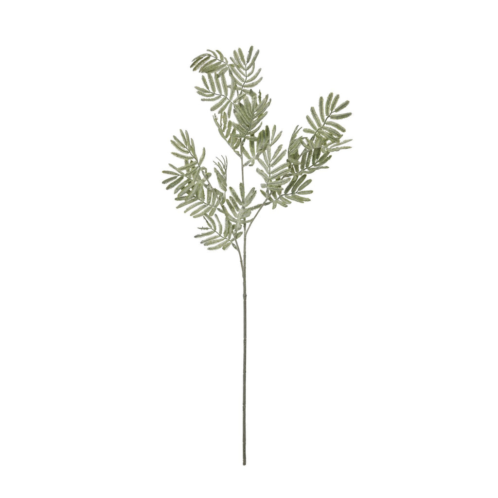 Full view of the artificial foliage stem against white, with a long bare lower stem and grey-green sprays branching above.