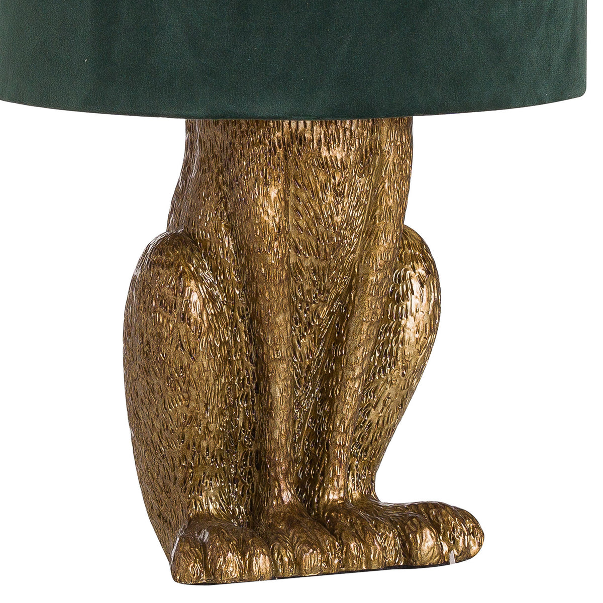 Close-up of the hare lamp's antique-gold torso, bent hind legs and broad sculpted feet beneath the green shade.
