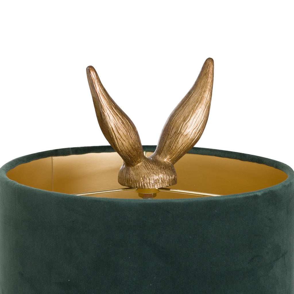 Antique-gold hare-ear finial above the dark-green shade, showing its gold-coloured interior and supports.