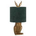 Hare table lamp with an antique-gold textured body, dark-green cylindrical shade and long ears projecting above.