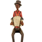Closer front view showing the musician’s face, black braces, yellow necktie detail and cream accordion with ribbed bellows and dark keyboard markings.