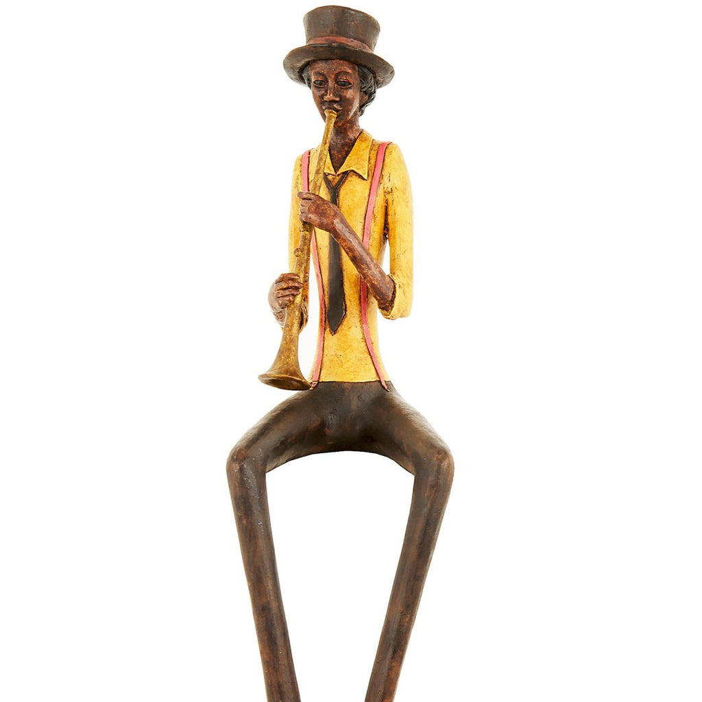 Closer view against white showing the trumpeter’s tall hat, dark tie, hands and gold-toned instrument, with the lower legs cropped.