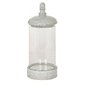 Tall cylindrical candle lantern with an empty clear chamber, pale grey-white speckled domed lid, egg-shaped finial and chevron-patterned base on a white background.