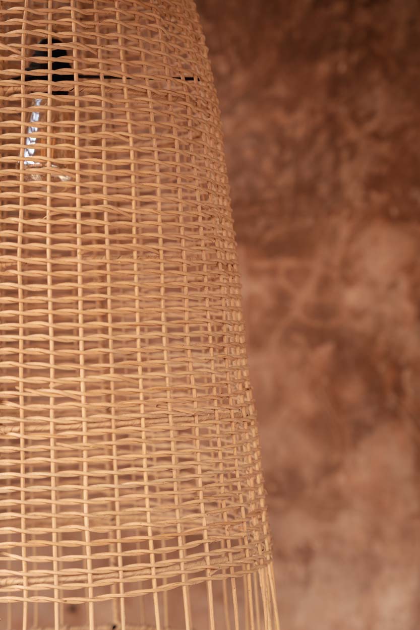 Elba Rattan Pendant Light – Natural, Large – close-up of the rattan weave against a terracotta wall