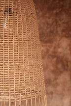 Elba Rattan Pendant Light – Natural, Medium – close-up of the rattan weave against a terracotta wall