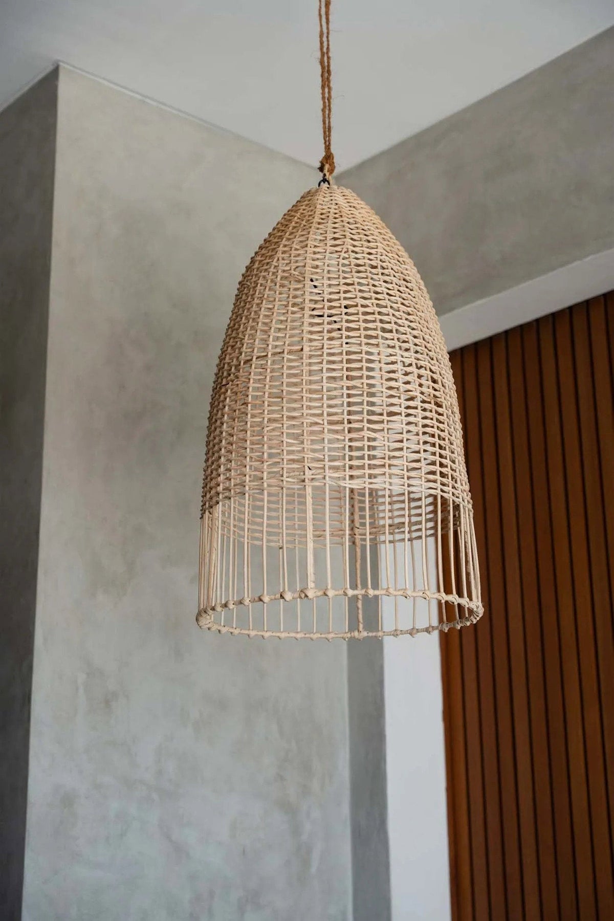 Elba Rattan Pendant Light – Natural, Medium – suspended against a pale interior wall