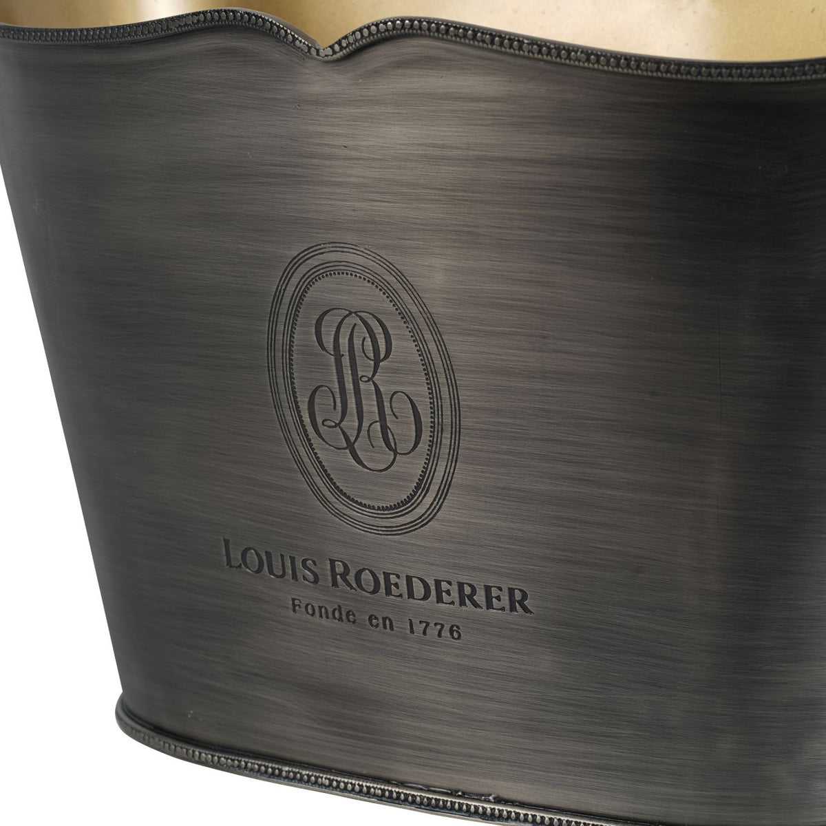 Close-up of the Louis Roederer emblem and lettering on the brushed exterior, with beaded trim along the rim and base.