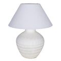 White table lamp with a rounded etched ceramic base and wide tapered fabric shade on a white background.