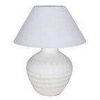 White table lamp with a rounded etched ceramic base and wide tapered fabric shade on a white background.