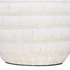 Close-up of the lower white ceramic base with vertical etched lines, horizontal bands and softly aged colour variations.