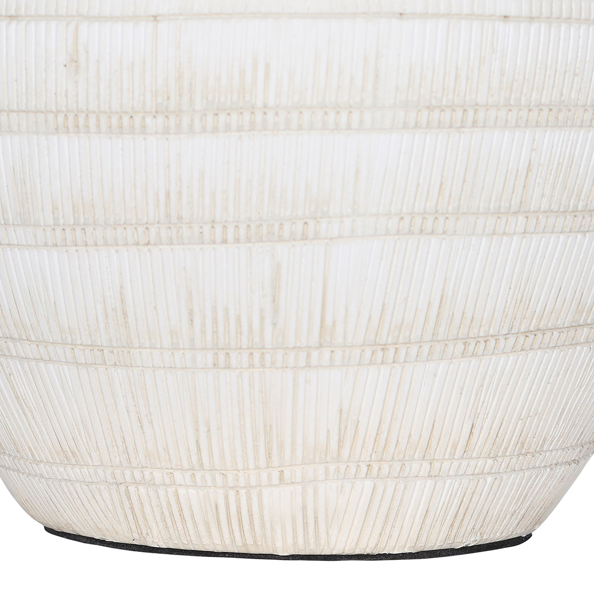Close-up of the lower white ceramic base with vertical etched lines, horizontal bands and softly aged colour variations.
