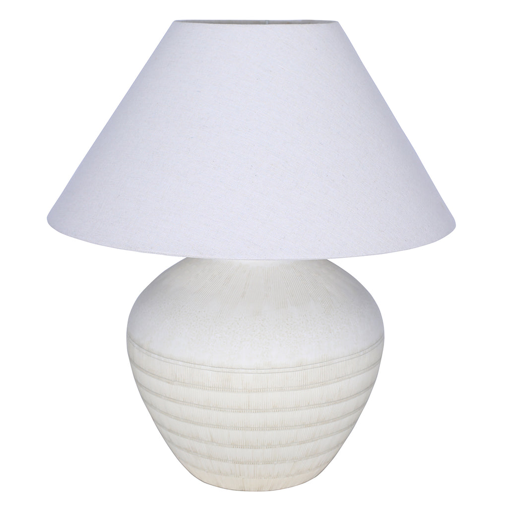 White table lamp with a rounded etched ceramic base and a broad tapered fabric shade against a white background.