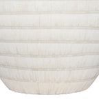 Close-up of fine vertical grooves crossed by horizontal bands on the lower white ceramic lamp base.