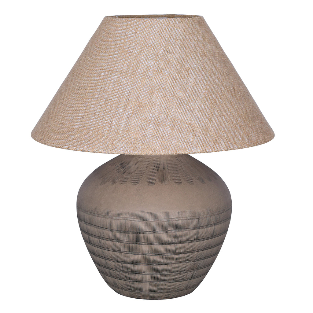 Unlit table lamp with a rounded brown etched ceramic base and wide tapered woven shade on a white background.